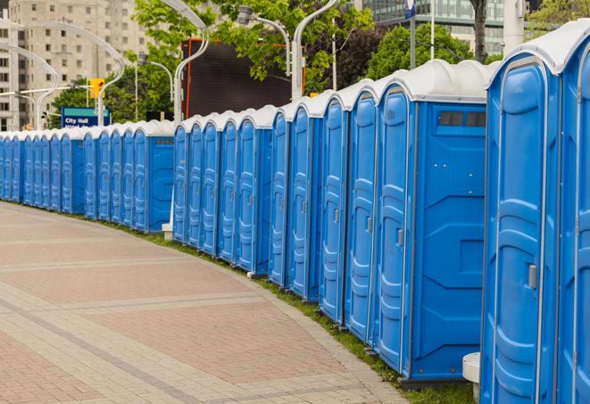 a row of portable restrooms set up for a large athletic event, allowing participants and spectators to easily take care of their needs in Lake Elsinore CA